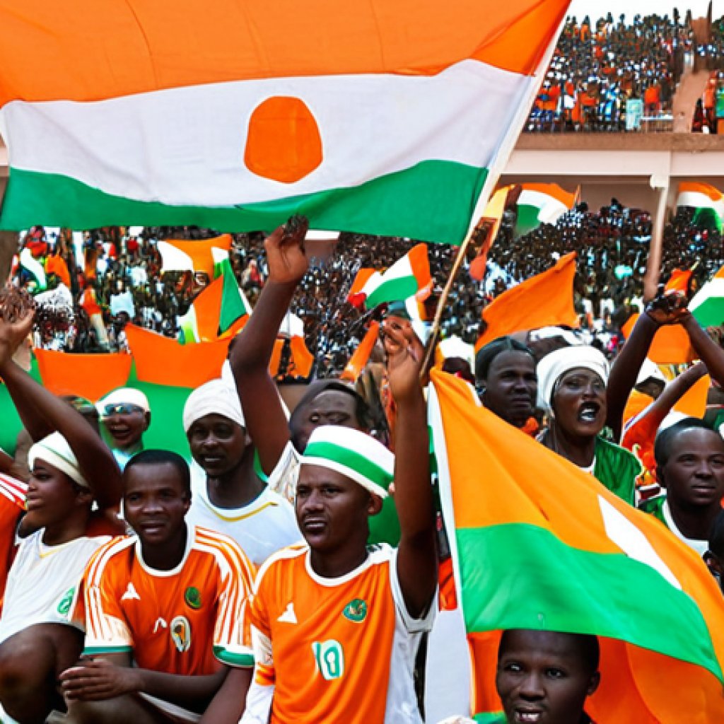 **Soccer Culture in Niger**: Create an image depicting a vibrant soccer match in Niger, showcasing enthusiastic fans in the stands, waving flags and cheering. The players on the field should display intense expressions of determination as they compete. Include elements of national pride, such as jerseys featuring the Niger flag.